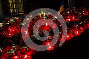 Red candles at night near the holodomor memorial in Ukraine photo