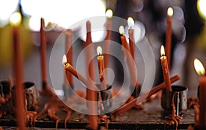 Red candles are placed on candlesticks to pay homage to the gods in the Chinese Naja Shrine
