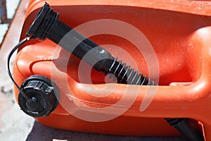 red canister with a funnel for gasoline