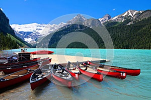 Red canoes in the blue waters of Lake Louise, Banff, Canada