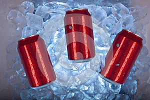 Red cans inside cool ice cooler surrounded by blue ice cubes ready for field day in Mexico