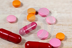 Red capsules and colorful pills