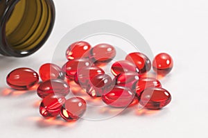 Red capsules near the box photo
