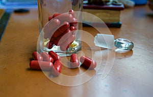 Red capsules and pharmacy glass bottle