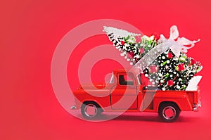 Red Car Carrying Christmas Tree on a Red Background. Christmas Background