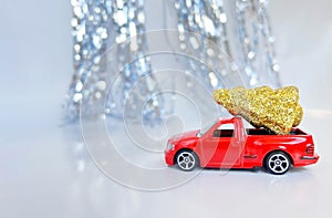 Red car carrying a Christmas tree - banner with place for text. festive shiny background for christmas