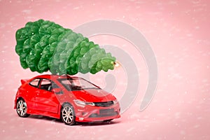 The red car is carrying the tree. Christmas candle