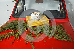 Red car with Christmas gifts on the roof