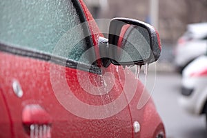 Red car covered with ice