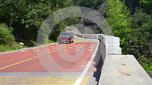 Red car driving  on colors road