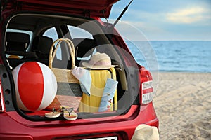 Red car with luggage on beach. Summer vacation trip