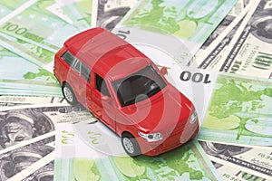 Red car and money, euro and dollars