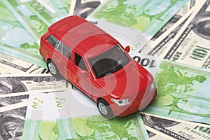 Red car and money, euro and dollars