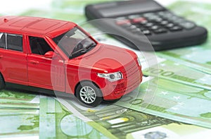 Red car and money, euro and dollars