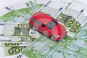 Red car and money, euro and dollars