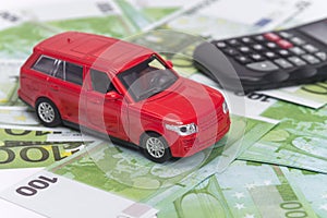 Red car and money, euro and dollars