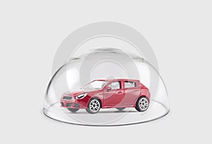 Red car protected under a glass dome