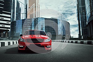 Red car stay on asphalt road in the city at daytime