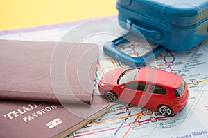 Red car, suitcase and passport on map background. Travel insurance covers loss suitcase, flight delays, cancellations, evacuations