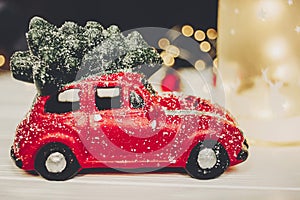 Red car toy with christmas tree on top and simple ornaments on w
