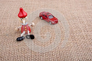 Red car and wooden Pinocchio doll