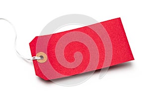 Red cardboard or paper luggage tag isolated on white