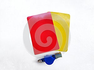 Red cards, yellow cards and blue whistles are placed on a white background