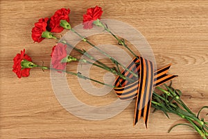 Carnation flowers with St. George`s ribbon - concept of victory photo