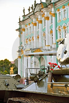 Red carnations in a gun cartridge on the middle of the Soviet ta