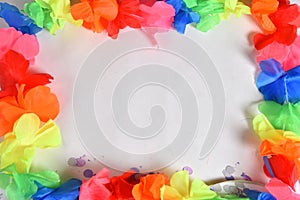 Red carnival costume mask in colorful confetti and streamers on pink background with space for text photo