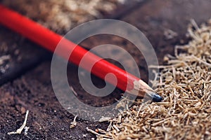Red carpenter pencil on desk in workshop
