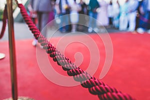 Red carpet with ropes and golden barriers on a luxury party entrance, cinema premiere film festival event award gala ceremony,
