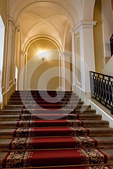 Red carpet on staircase in luxury interior