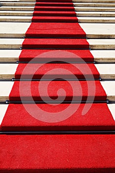 Red carpet on a stairway used to mark the route taken by heads of state, vips and celebrities on ceremonial and formal