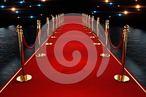 Red carpet for the stars, with gold stands and paparazzi flashes. Pop star concept, reception, ceremony, show, VIP. Copy space, 3D