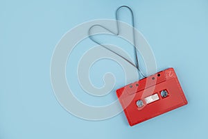 Red cassette tape on background