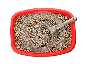 Red cat litter tray with filler and scoop isolated on white, top view