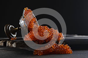 Red caviar. Caviar spilled out of the vase. Lots of caviar. Salmon roe. A delicacy. Seafood. A delicious and healthy