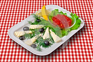 Red caviar with Fetta cheese, lemon, black olives and vegetables photo