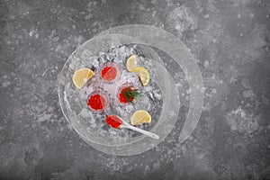 Red caviar in ice bowls on gray background. Top view, copy space. Food background
