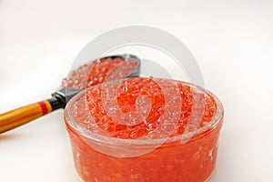 Traditional russian food. Red salmon caviar glass jar.