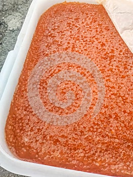 red caviar in plastic container. Salmon caviar, diet food