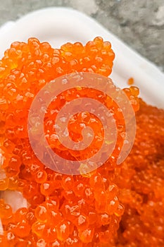 red caviar in plastic container. Salmon caviar, diet food