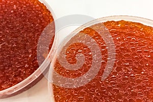 red caviar in plastic container. Salmon caviar, diet food