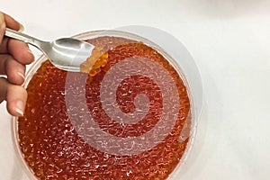 red caviar in plastic container. Salmon caviar, diet food