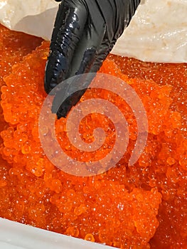 red caviar in plastic container. Salmon caviar, diet food