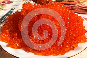 Red caviar on plate on the table. Salmon caviar. Dietary nutriti