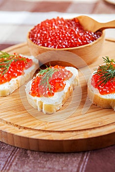 Red caviar sandwiches on plate