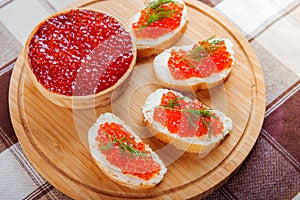 Red caviar sandwiches on plate