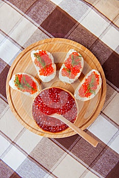 Red caviar sandwiches on plate